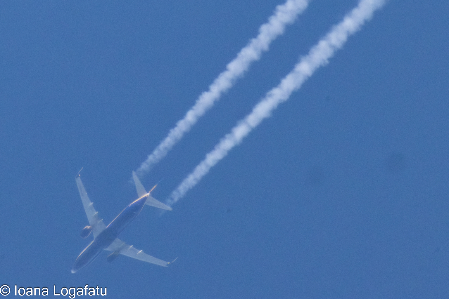 Airplane soaring through the clear blue sky